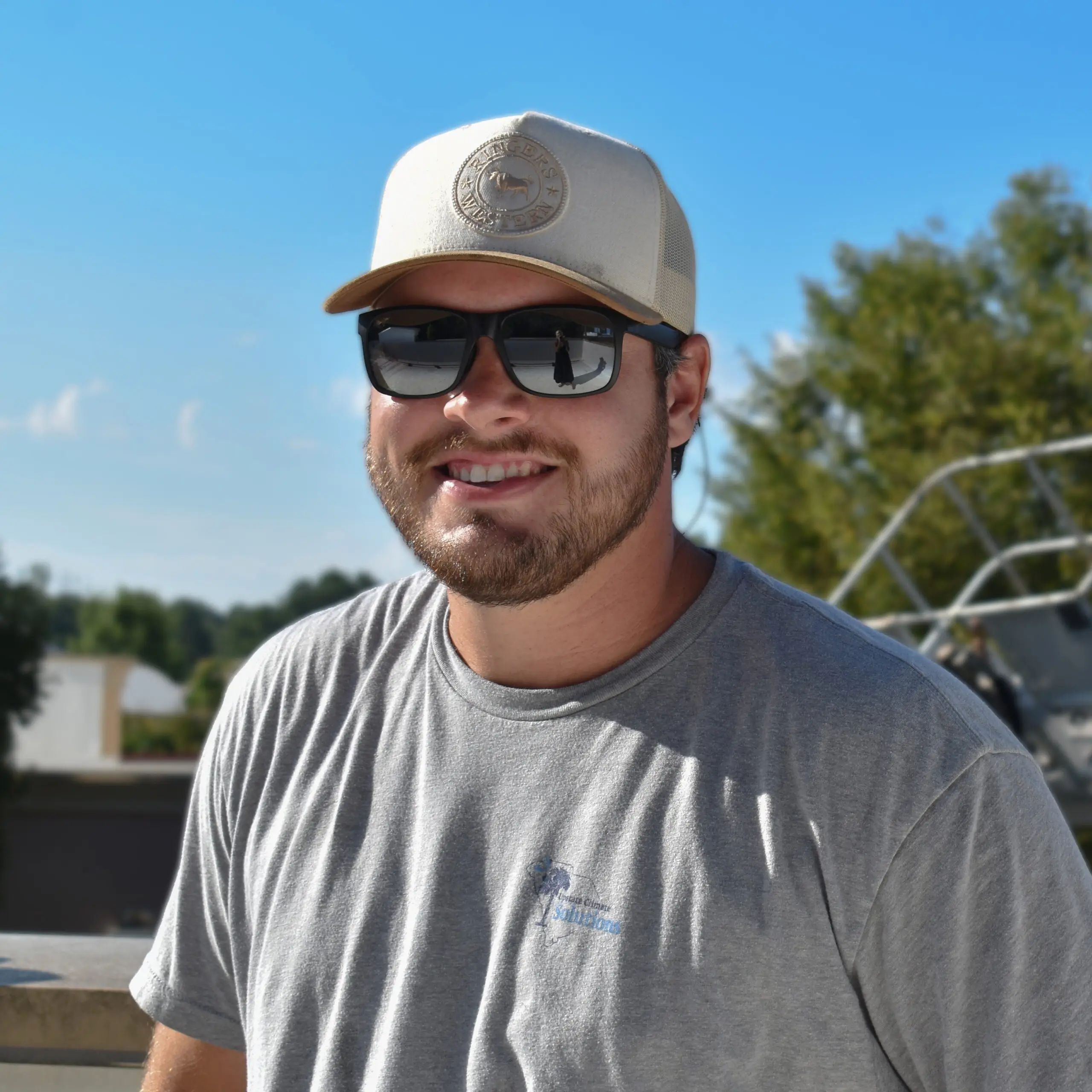 Owner of Upstate Climate Solutions, Draysen Turner - smiling at camera with sunglasses on and hat on