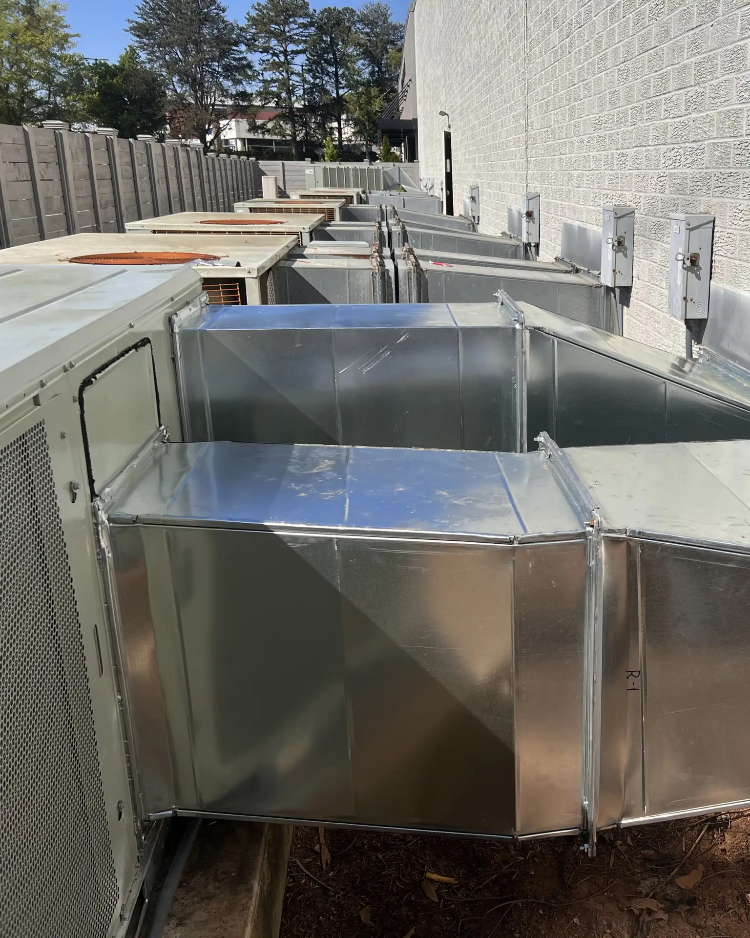 Ductwork on a commercial property outside - multiple units lined up
